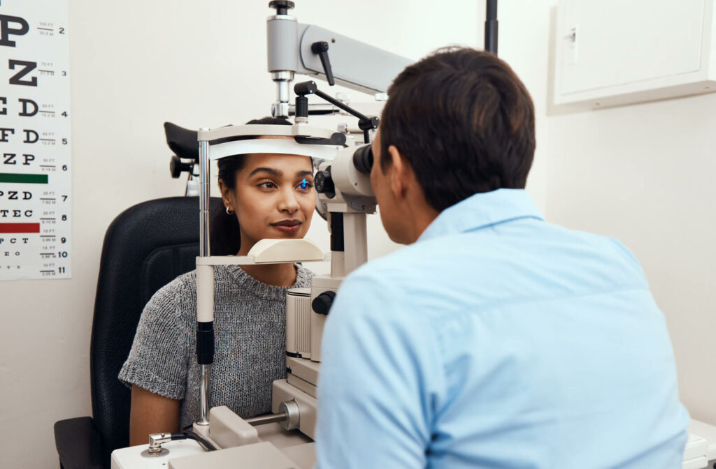 a woman has her eyes examined at the eye doctor with a slit lamp
