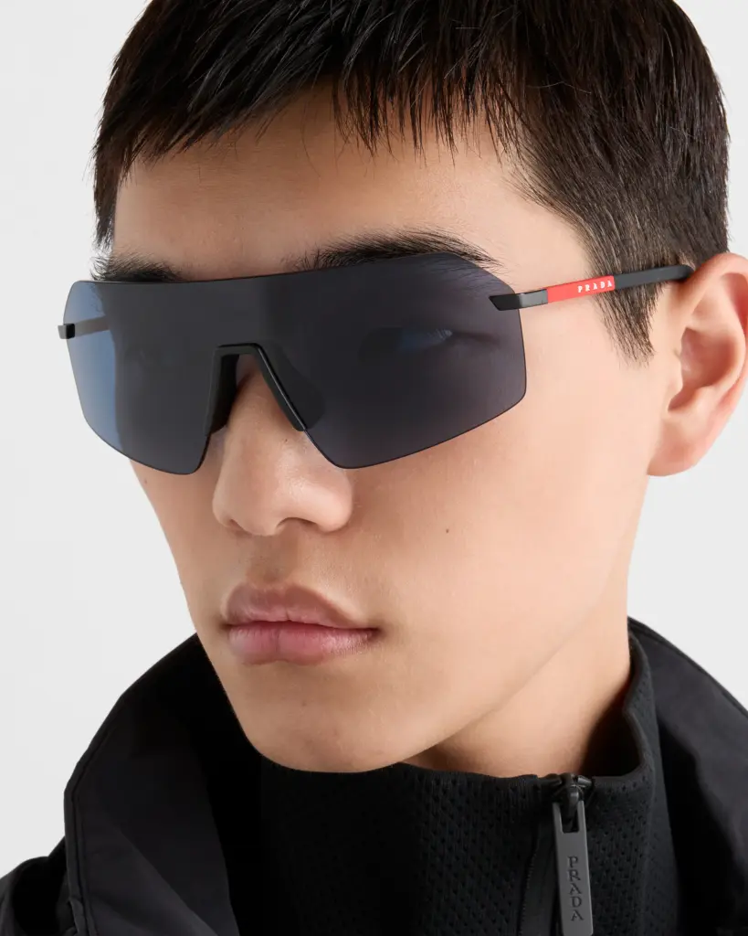 optometry-eyes-eyewear-eyeglasses-glasses-lenses-blue-light-filter-exposure-eye-fatigue-strain-dry-eye-exams-annual-comprehensive-cee-aee-optometrist-optical-illusions-eye-care-eyecare-vision-optometrist-eye-care-eyecare-opticians-eye-doctor-near-me-cartier-lindberg-chrome-hearts-eyewear-glasses-eyeglasses-sunglasses-frames-polarized-designer-luxury-Prada Linea Rossa